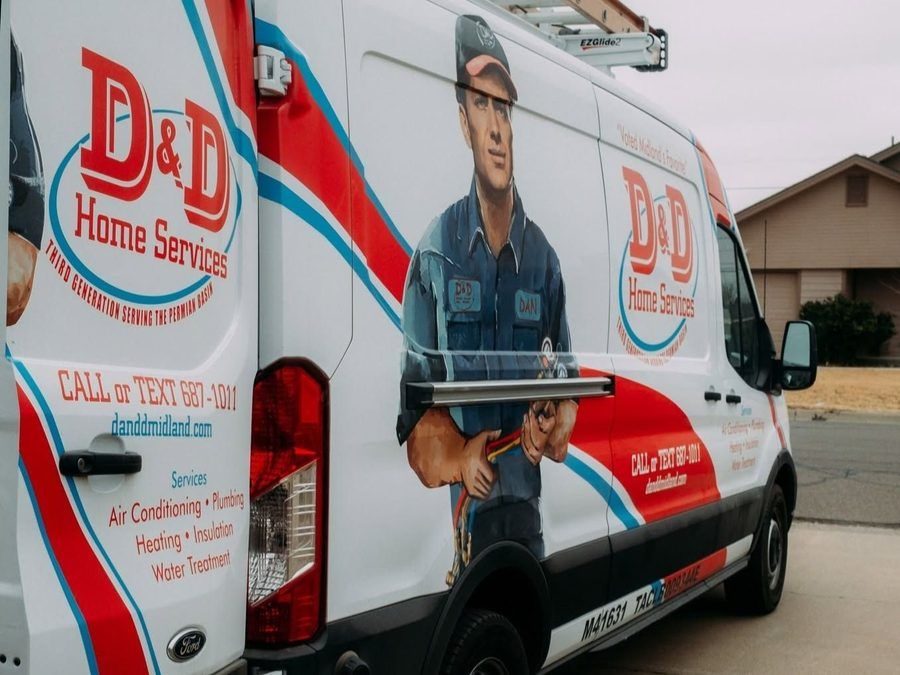 D&D Plumbing, Heating, and Air Conditioning van with a technician illustration and company branding, showing contact info on a residential street