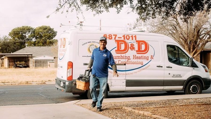 D&D Plumbing, Heating, and Air Conditioning service technician arriving at a home with a fully stocked service van for professional plumbing, heating, or air conditioning service.